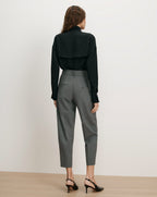 Veronica Beard Black silk blouse, gray wool trousers.