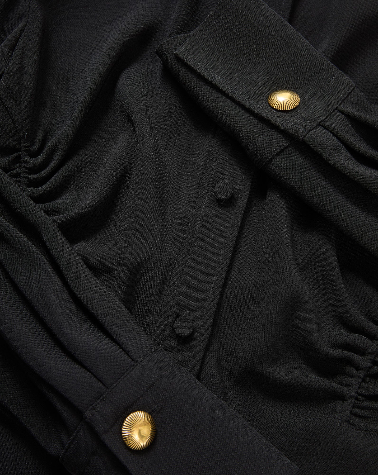 Veronica Beard Black blouse with gold buttons.