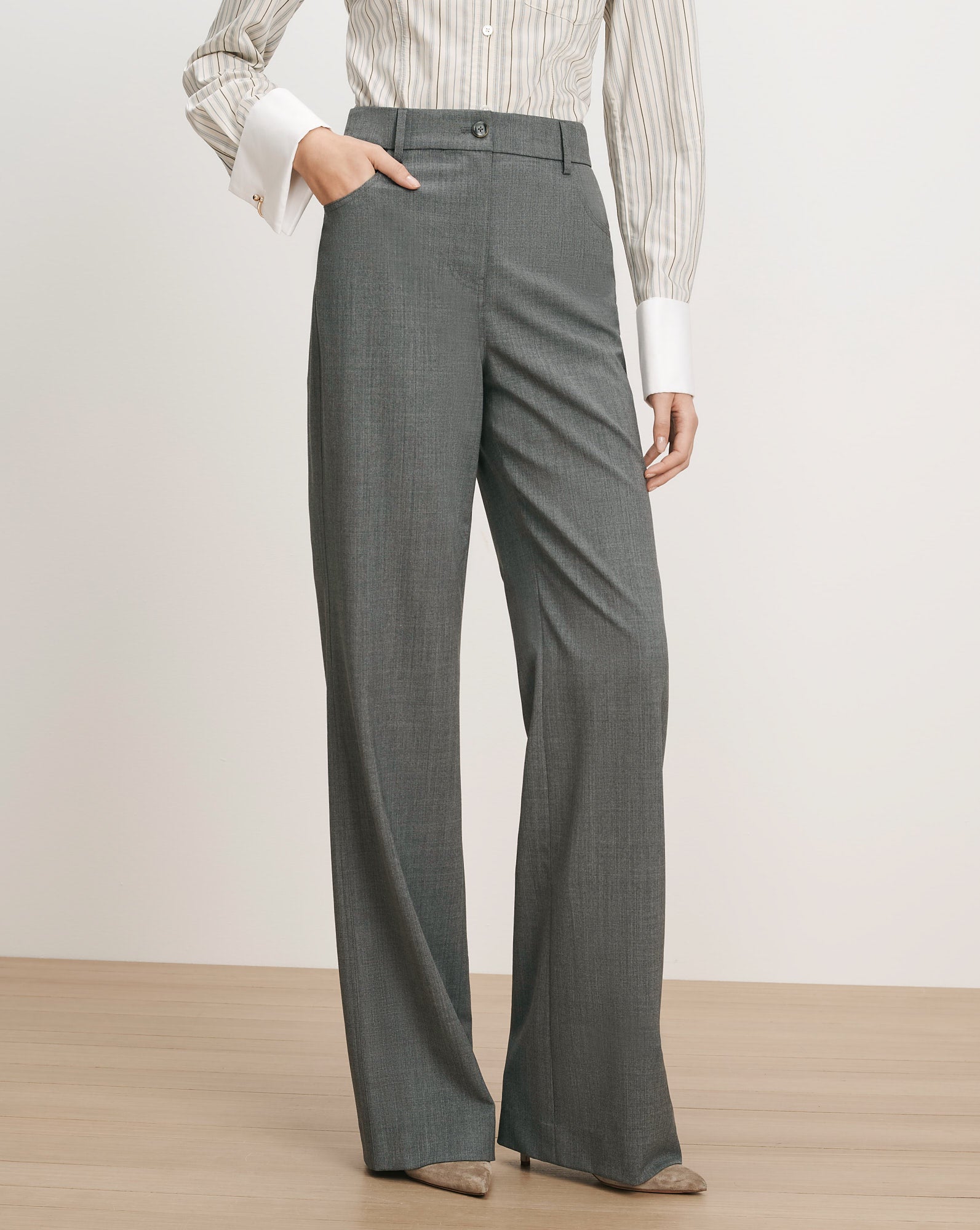Veronica Beard Gray wide-leg trousers with a striped button-up shirt.