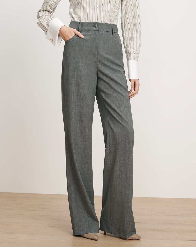 Veronica Beard Gray wide-leg trousers with a striped button-up shirt.