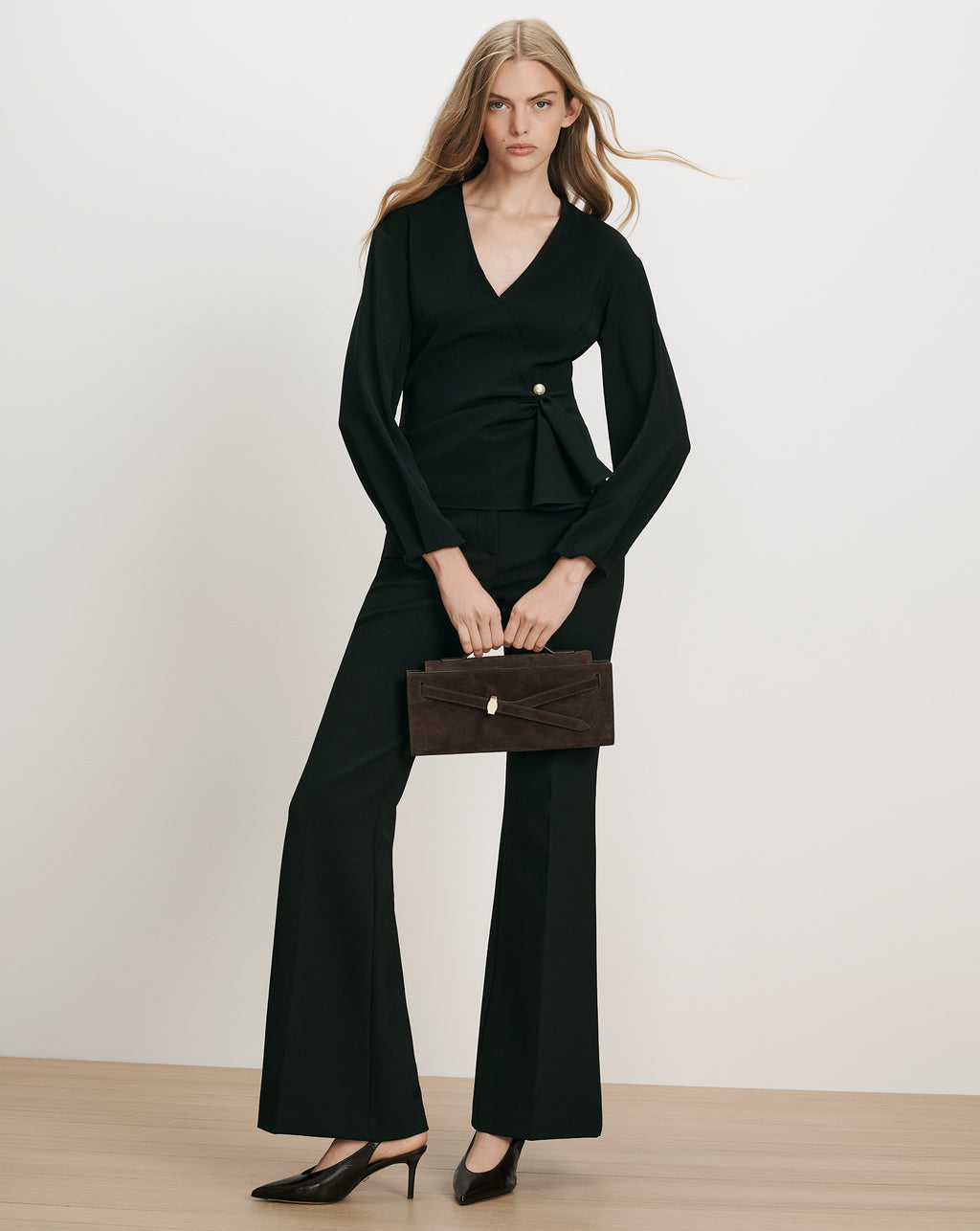 Veronica Beard Black wrap blouse and trousers, brown suede handbag.