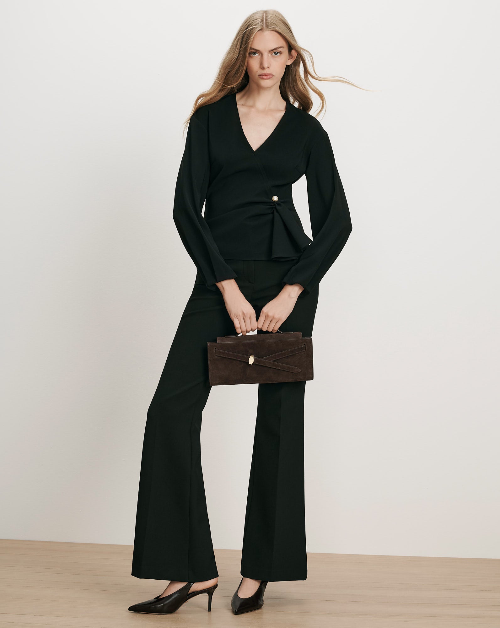 Veronica Beard Black wrap blouse and trousers, brown suede handbag.