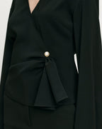 Veronica Beard Black wrap blouse with pearl button and draped detail.