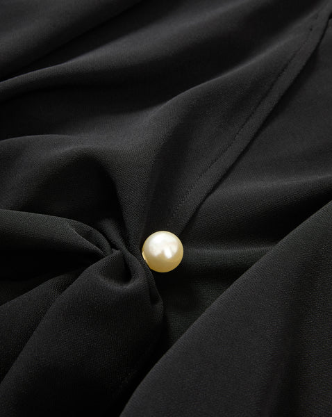 Veronica Beard Black blouse with a pearl button.