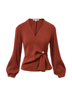 Veronica Beard Rust wrap blouse with pearl button detail.