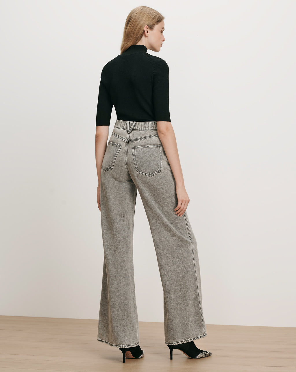 Veronica Beard Black ribbed turtleneck top, gray wide-leg jeans