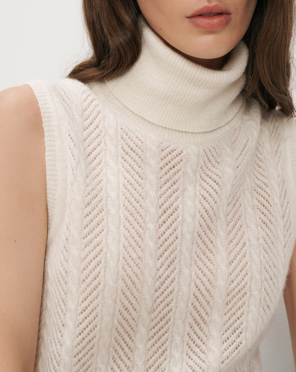 Veronica Beard White sleeveless turtleneck sweater with cable knit pattern.