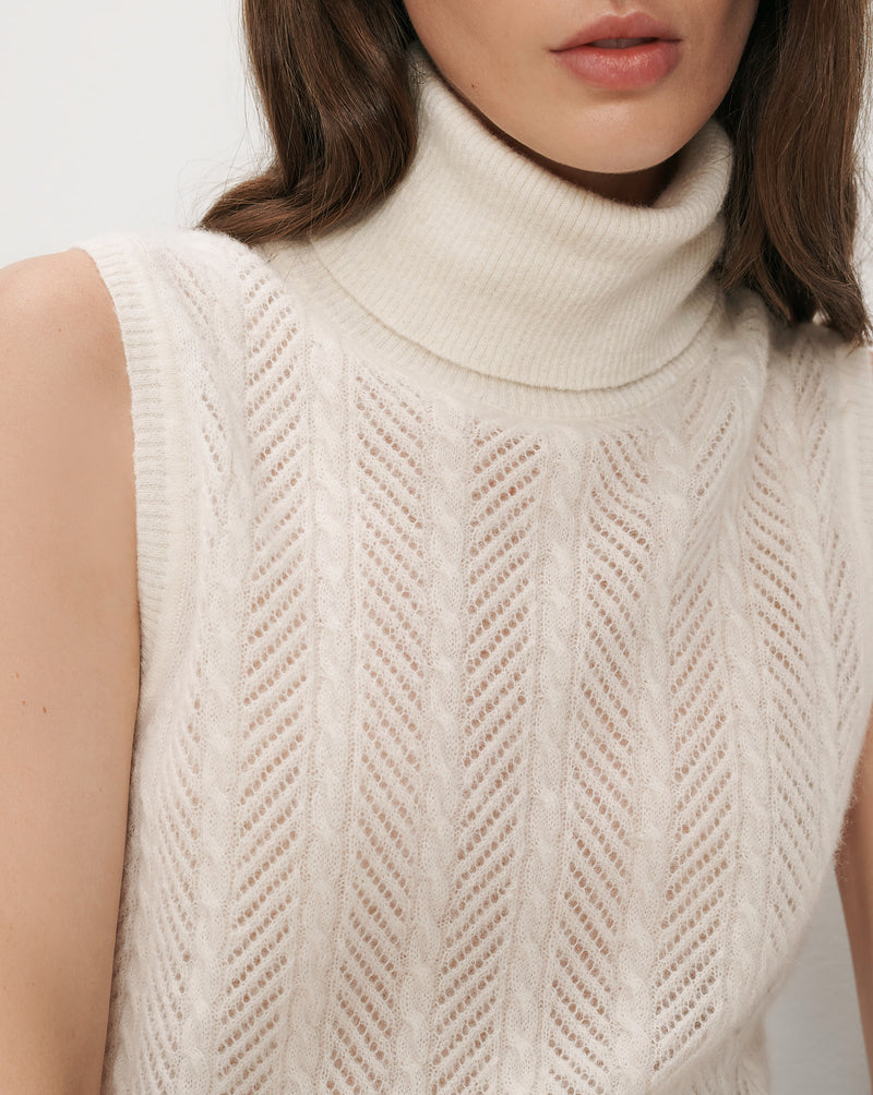 Veronica Beard White sleeveless turtleneck sweater with cable knit pattern.