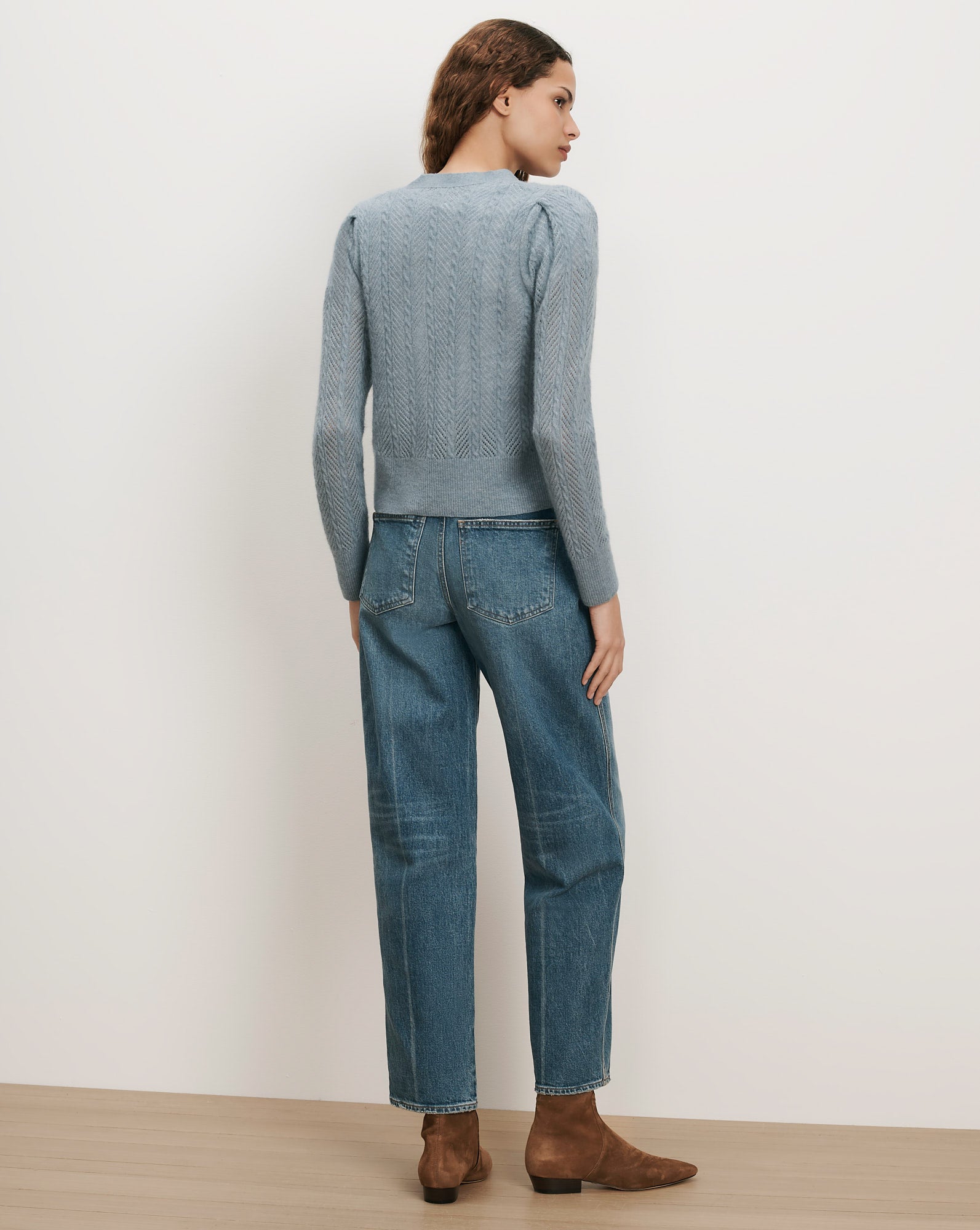 Veronica Beard Blue cable knit sweater, puff sleeves, and straight-leg jeans.
