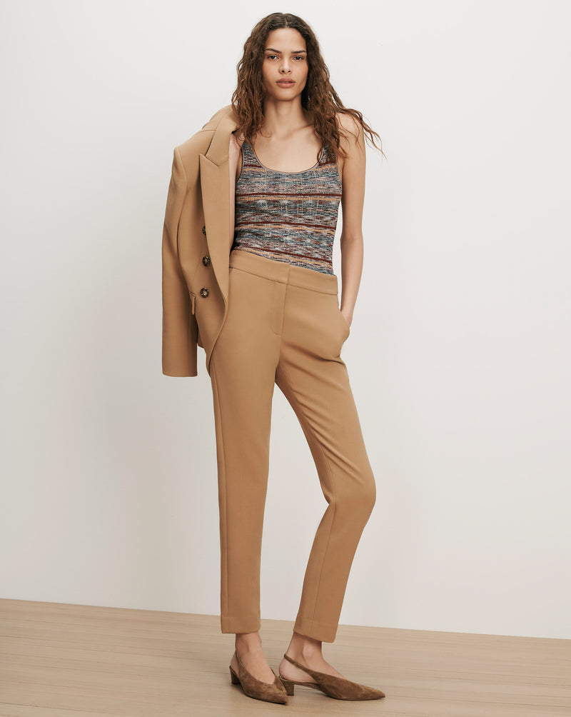 Veronica Beard Tan blazer, striped knit tank, and tan trousers.