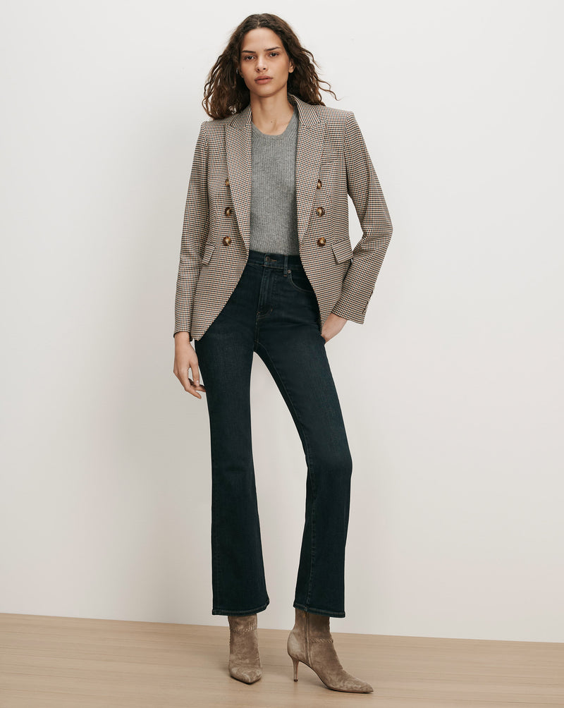 Veronica Beard Brown plaid double-breasted blazer, gray sweater, dark wash jeans.