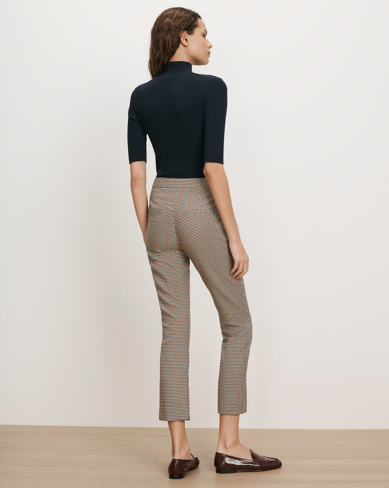 Veronica Beard Black ribbed short-sleeve turtleneck and brown plaid cropped pants.