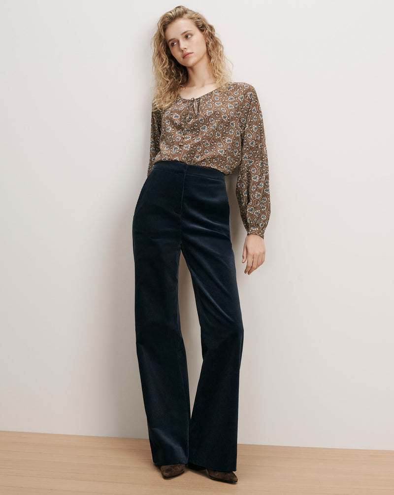 Veronica Beard Brown floral blouse, navy corduroy wide-leg pants.