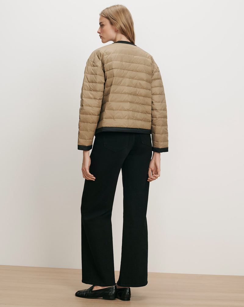 Veronica Beard Tan quilted jacket with black trim.