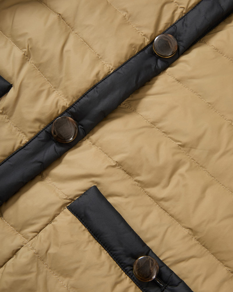 Veronica Beard Tan quilted jacket with black trim and brown buttons.