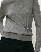 Veronica Beard Gray knit sweater with pearl and gold button detail.