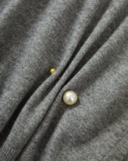 Veronica Beard Gray knit sweater with pearl and gold button details.