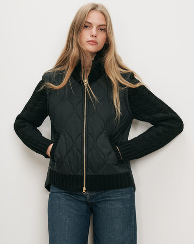 Veronica Beard Black quilted vest with knit sleeves.
