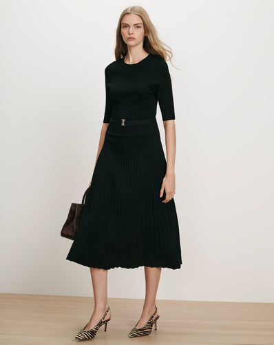 Veronica Beard Black ribbed knit midi dress with pleated skirt.