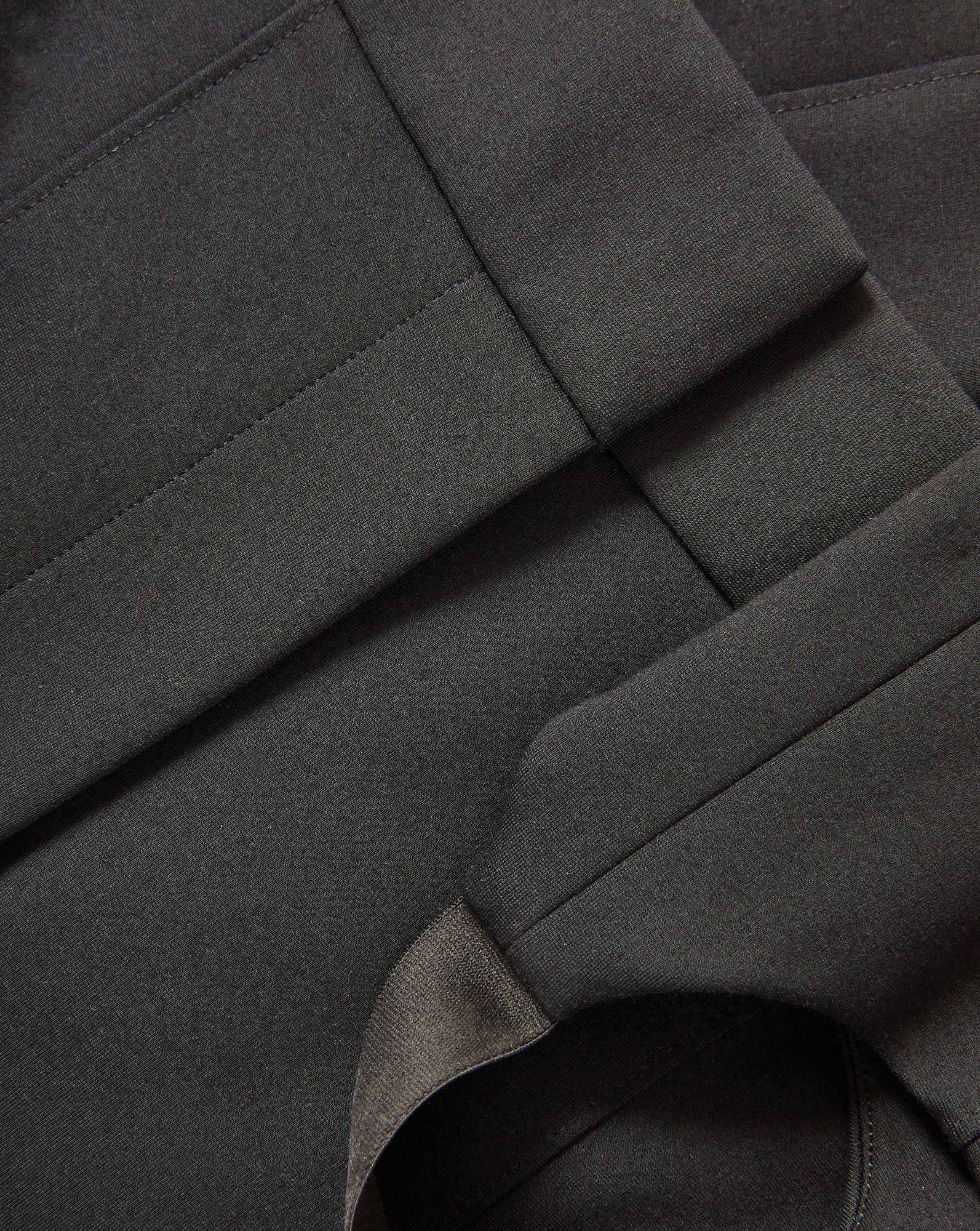 Veronica Beard Black woven fabric with stitched seams.