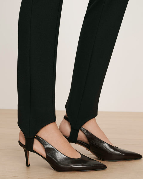 Veronica Beard Black stirrup pants with black slingback heels.