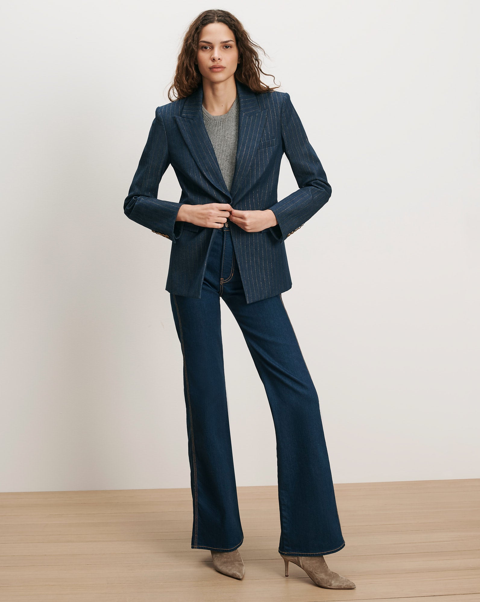 Veronica Beard Navy pinstripe blazer, gray sweater, dark wash jeans.