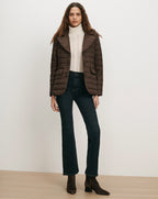 Veronica Beard Brown quilted jacket, cream sweater, dark wash jeans.