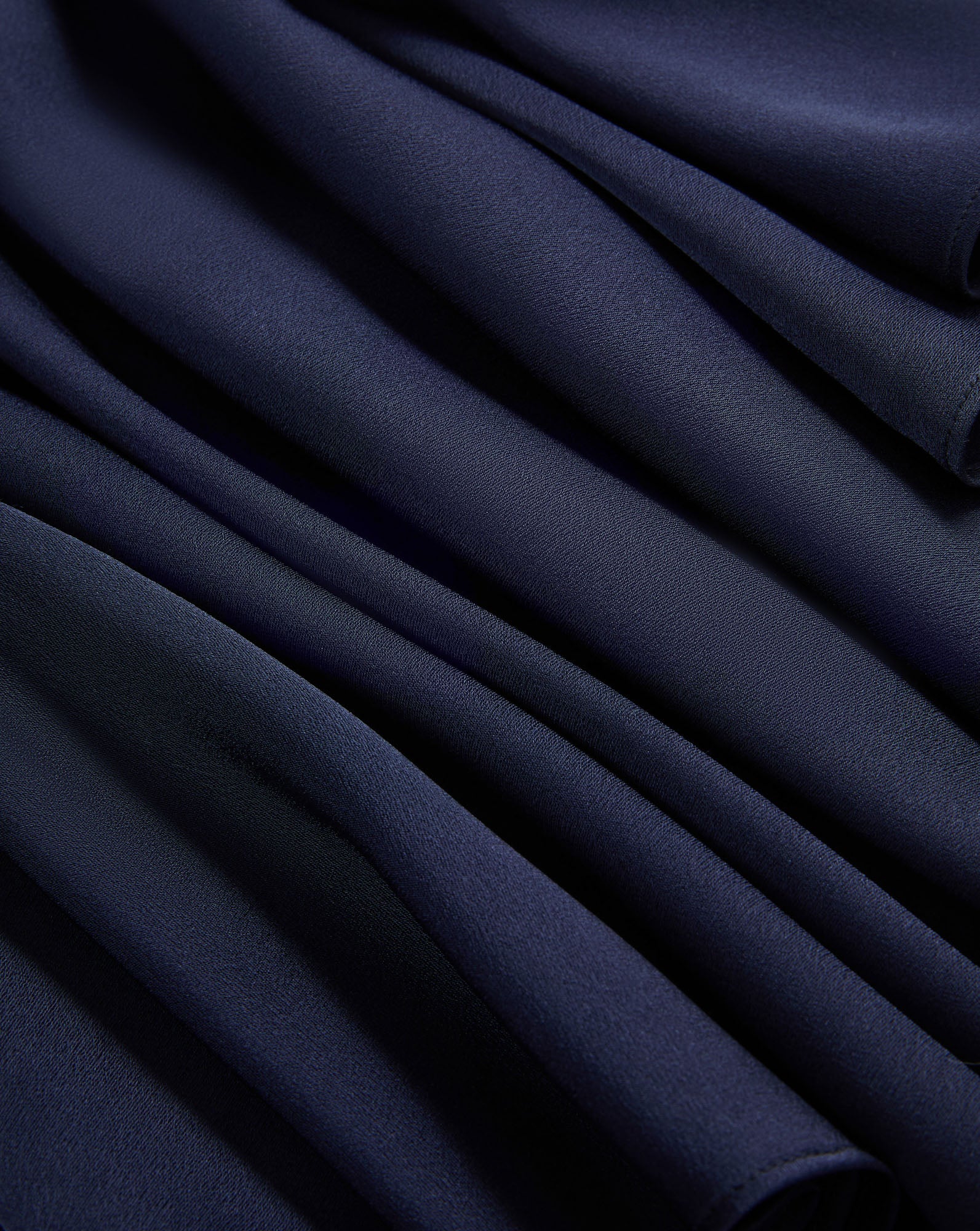 Veronica Beard Navy blue pleated fabric with soft folds.
