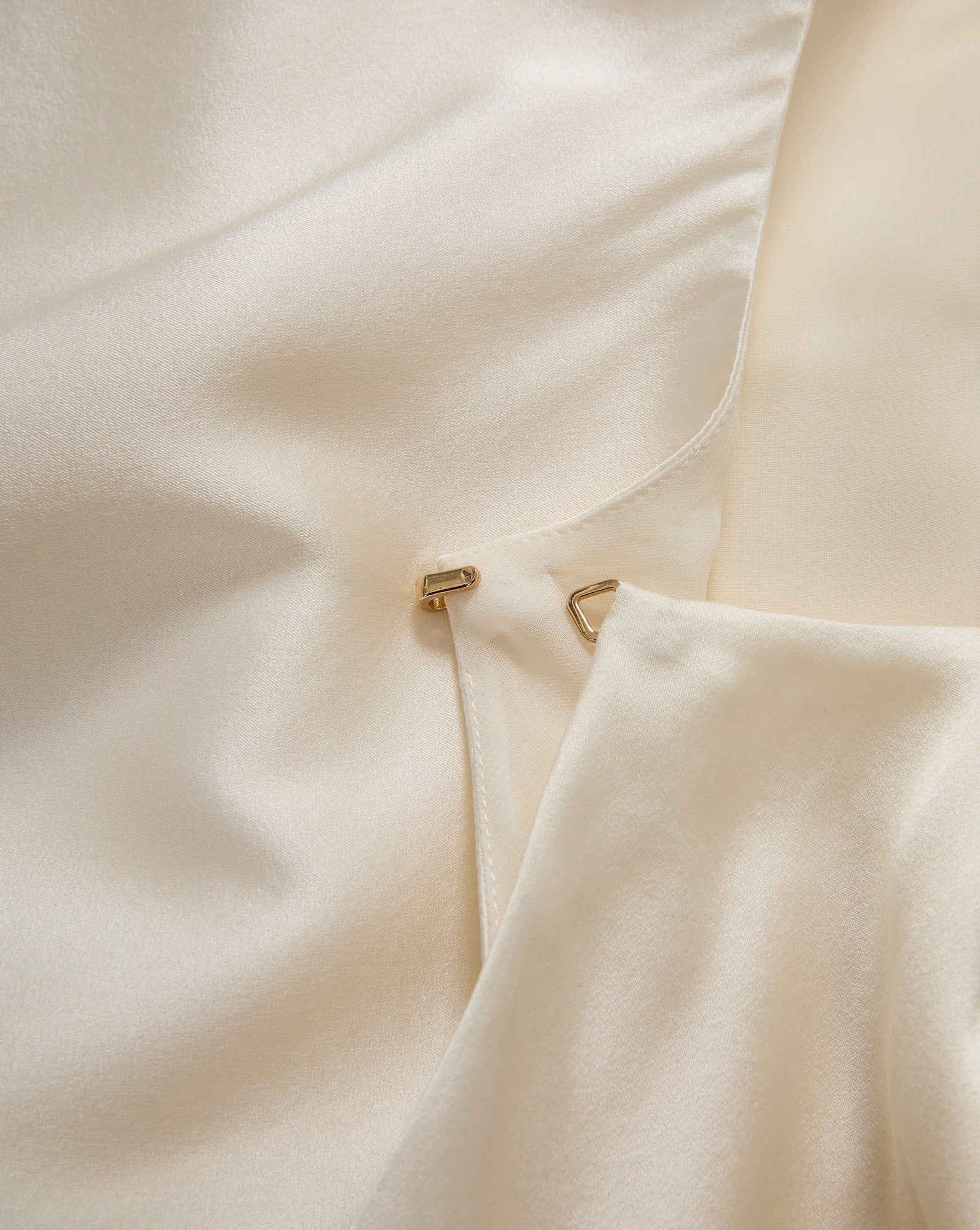 Veronica Beard Cream satin blouse with hook-and-eye closure.