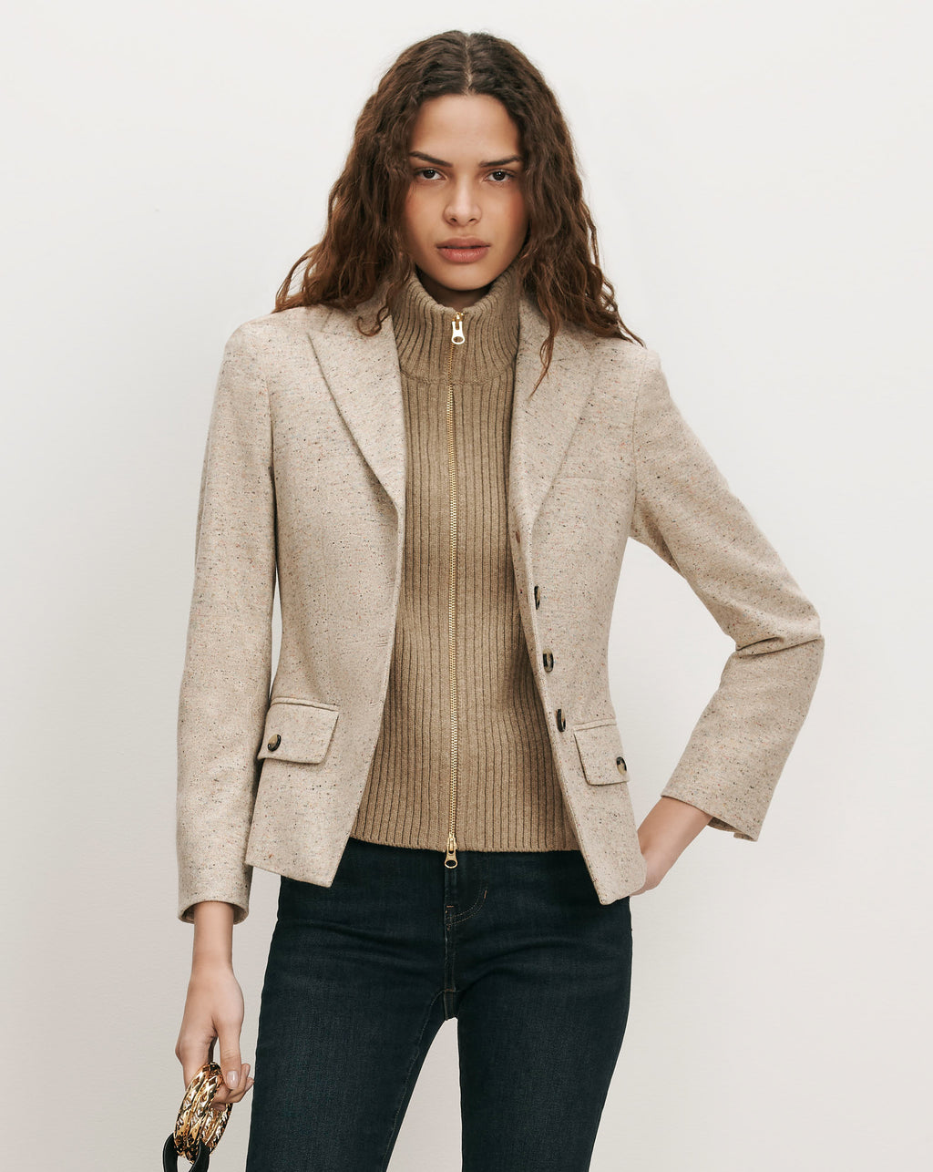 Veronica Beard Beige tweed blazer, ribbed turtleneck, and dark wash jeans.
