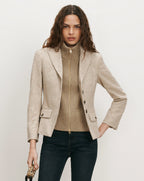 Veronica Beard Beige tweed blazer, ribbed turtleneck, and dark wash jeans.