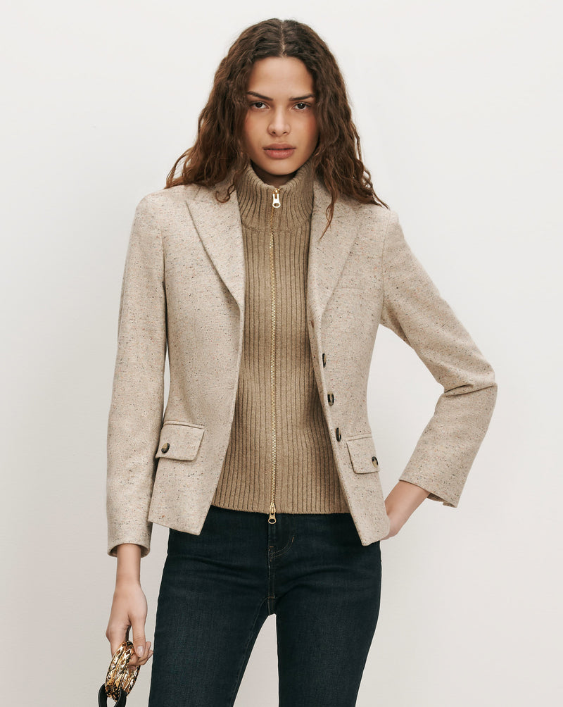 Veronica Beard Beige tweed blazer, ribbed turtleneck, and dark wash jeans.