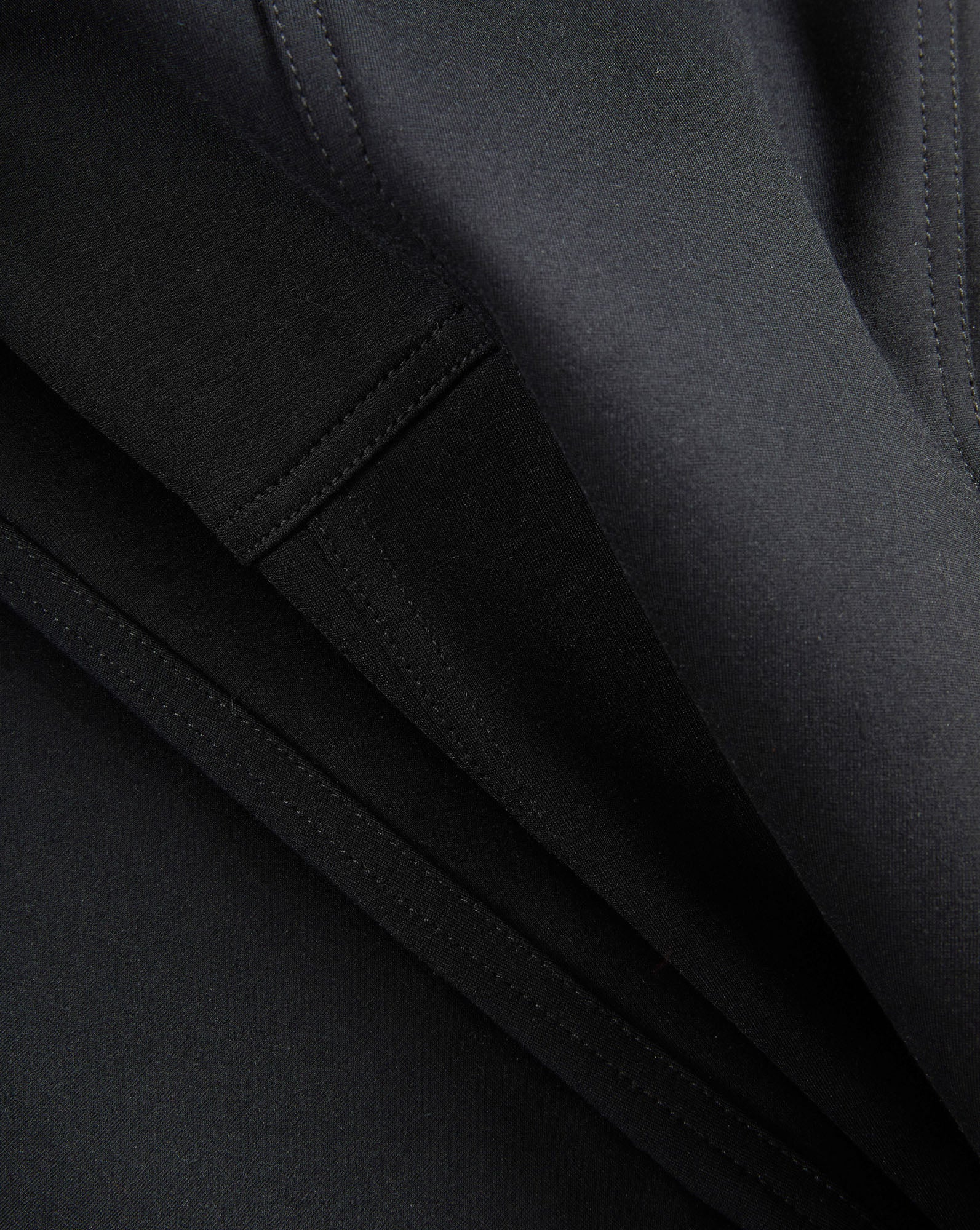 Veronica Beard Black fabric with visible stitching and folds.