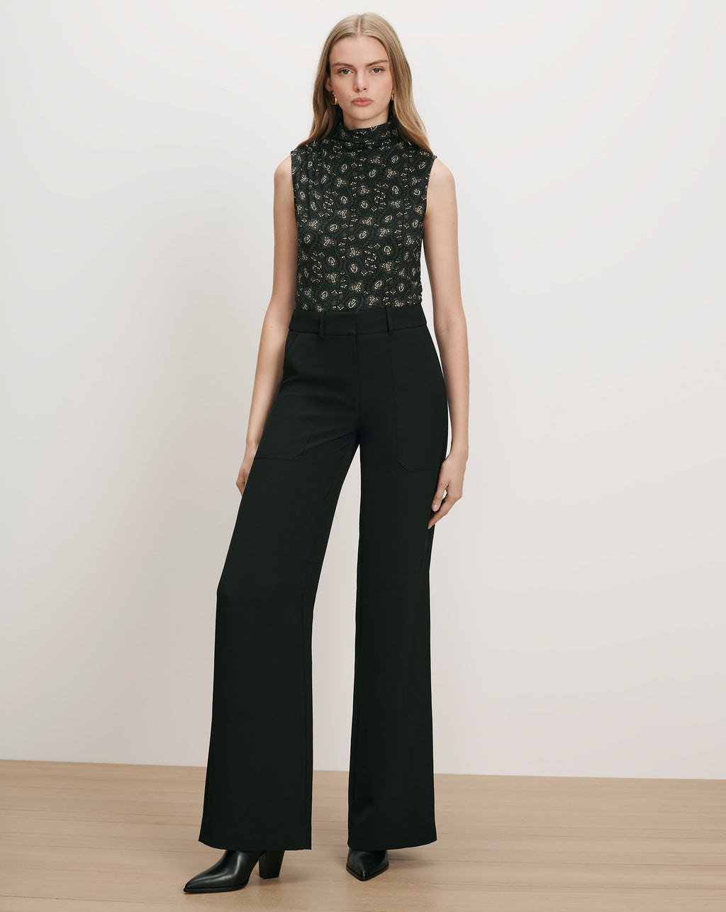 Veronica Beard Black floral sleeveless top and black wide-leg pants.