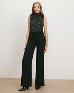 Veronica Beard Black floral sleeveless top and black wide-leg pants.