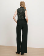 Veronica Beard Black floral sleeveless blouse and black wide-leg trousers.