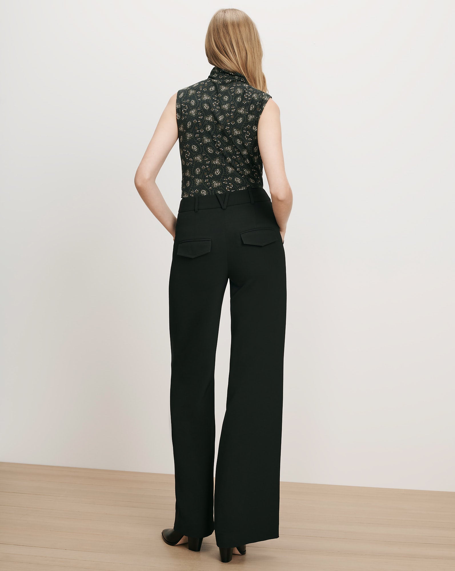 Veronica Beard Black floral sleeveless blouse and black wide-leg trousers.