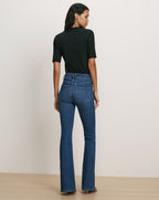 Veronica Beard Blue flared denim jeans and black top.