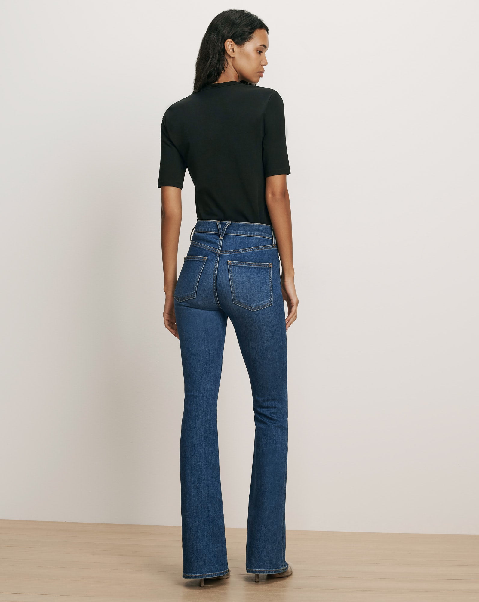Veronica Beard Blue flared denim jeans and black top.