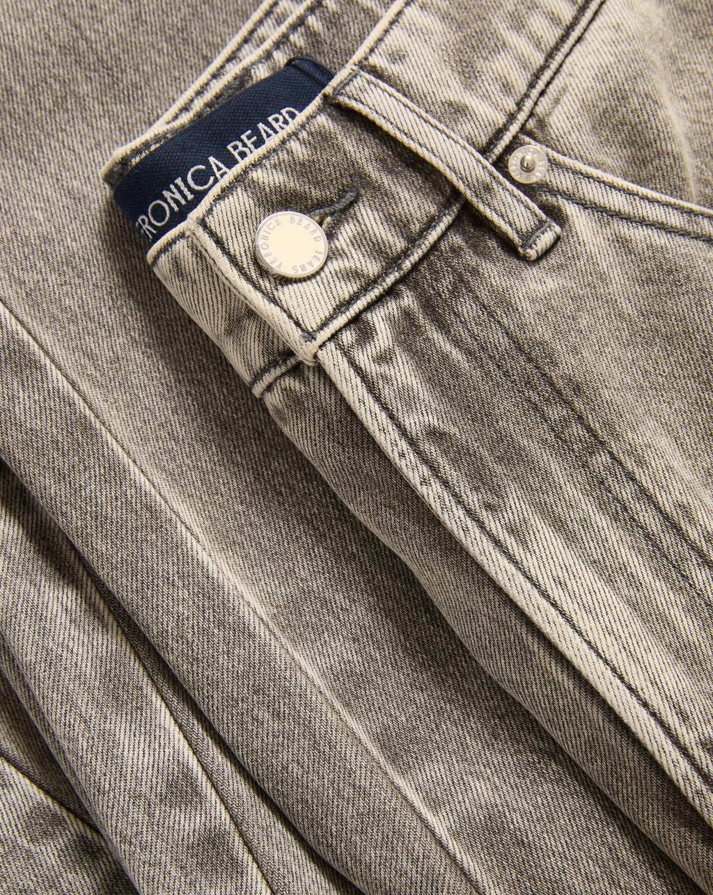 Veronica Beard Washed gray denim jeans with a button closure.
