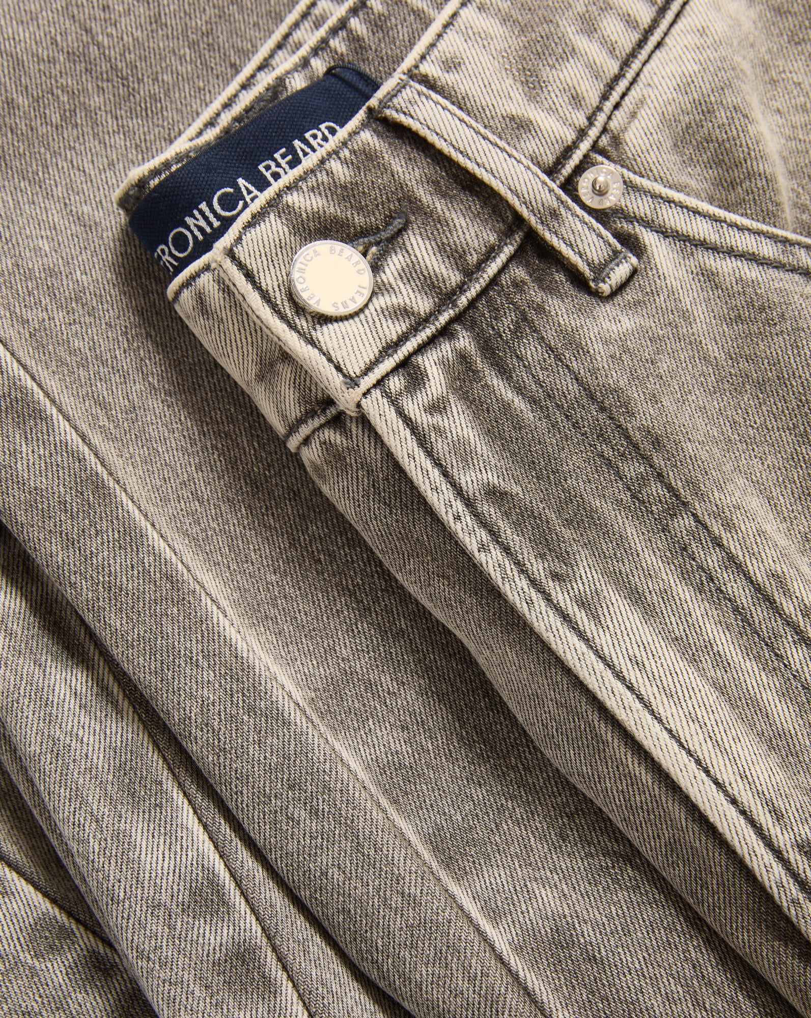 Veronica Beard Washed gray denim jeans with a button closure.