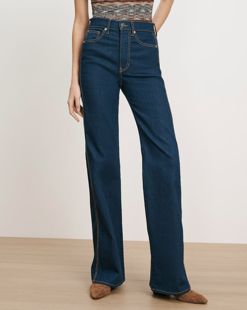 Veronica Beard Dark wash denim wide-leg jeans with tan stitching.
