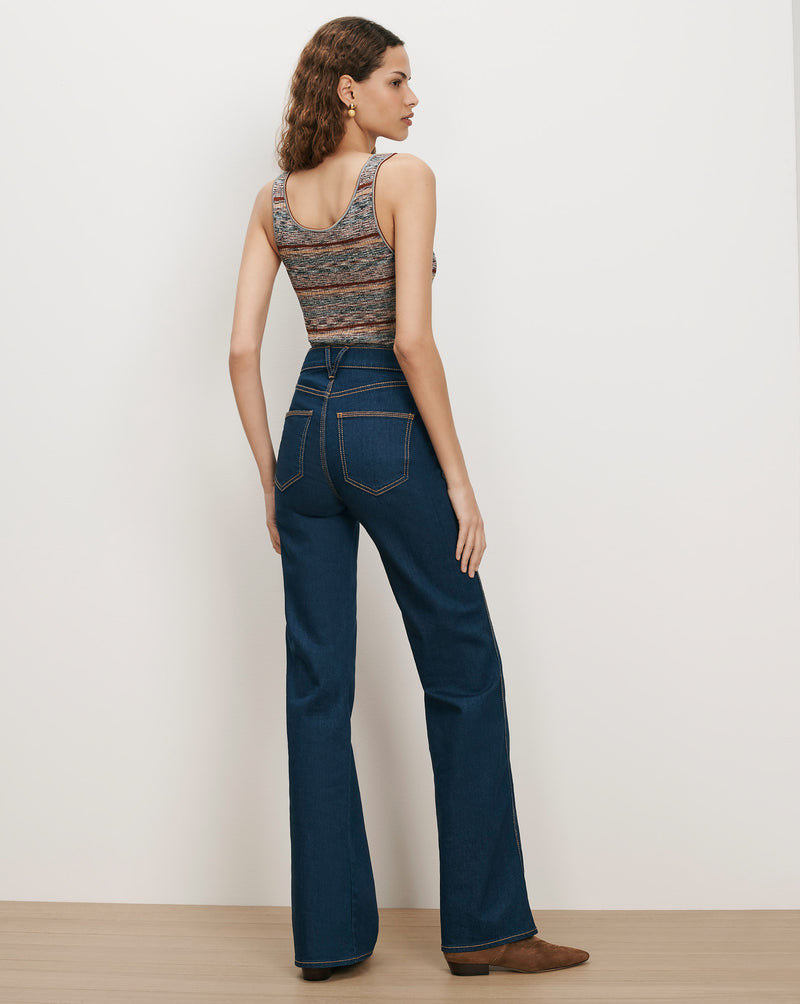 Veronica Beard Dark wash flared jeans and a striped knit tank top.