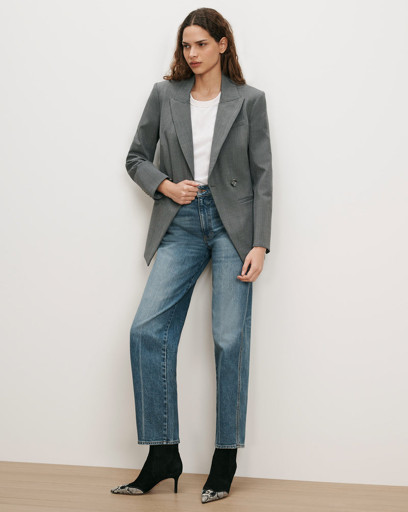 Veronica Beard Gray double-breasted blazer, white t-shirt, blue jeans, black boots.