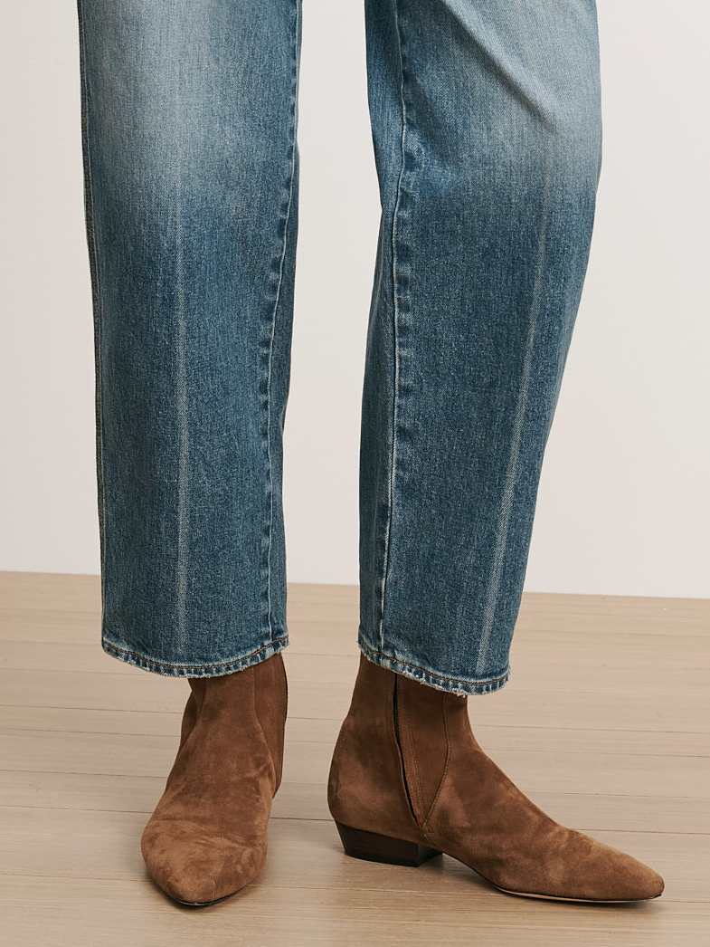 Veronica Beard Blue Jeans and brown suede boots.