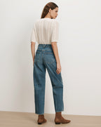 Veronica Beard White knit short-sleeve sweater, blue straight-leg jeans.
