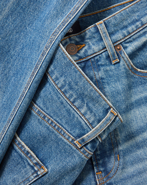 Veronica Beard Blue denim jeans with copper button and stitching.
