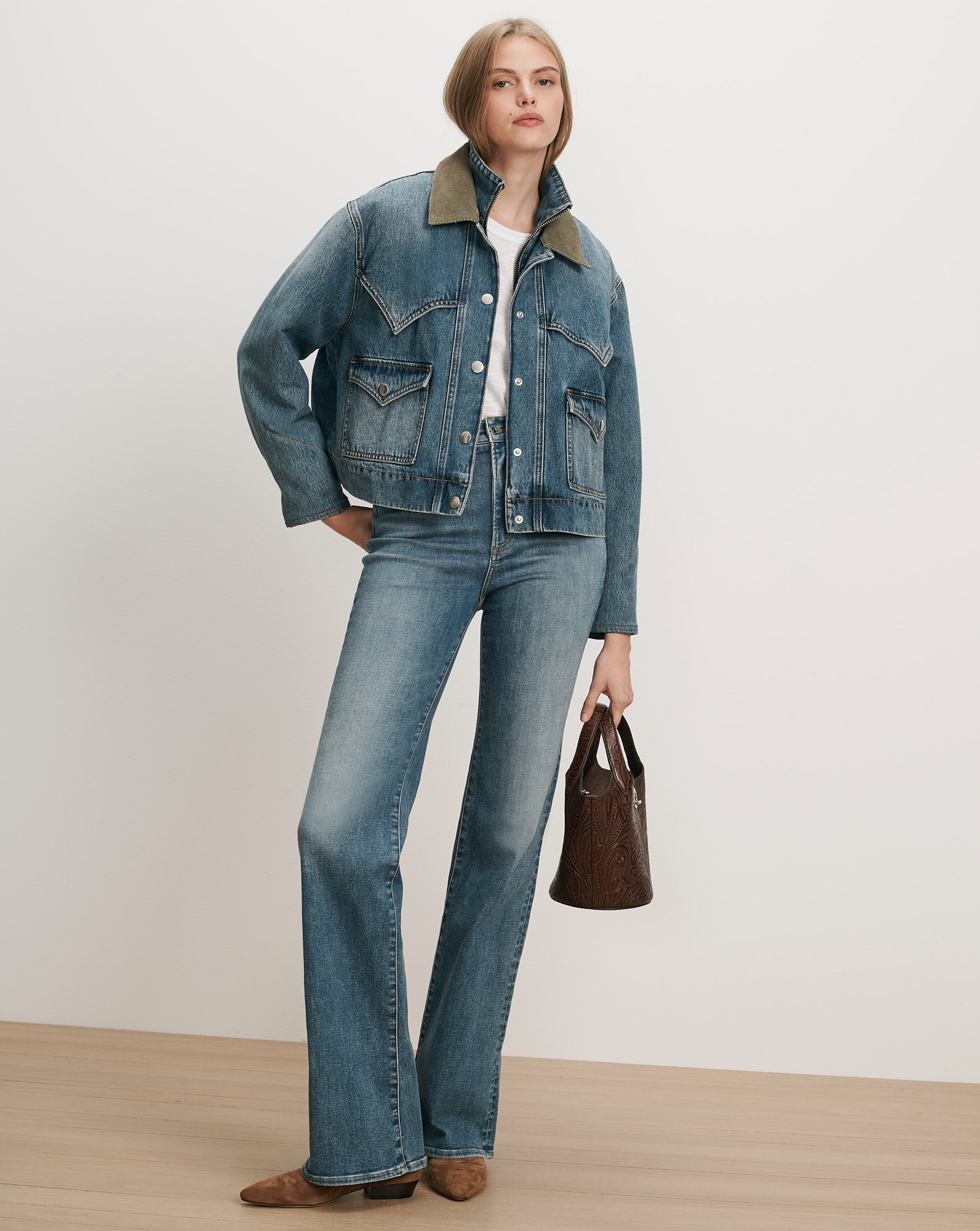 Veronica Beard Blue denim jacket and jeans, white t-shirt, brown handbag.