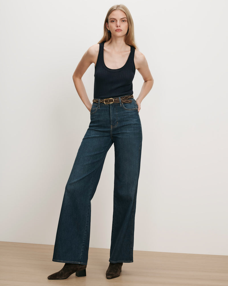 Veronica Beard Black ribbed tank top, dark wash wide-leg jeans.