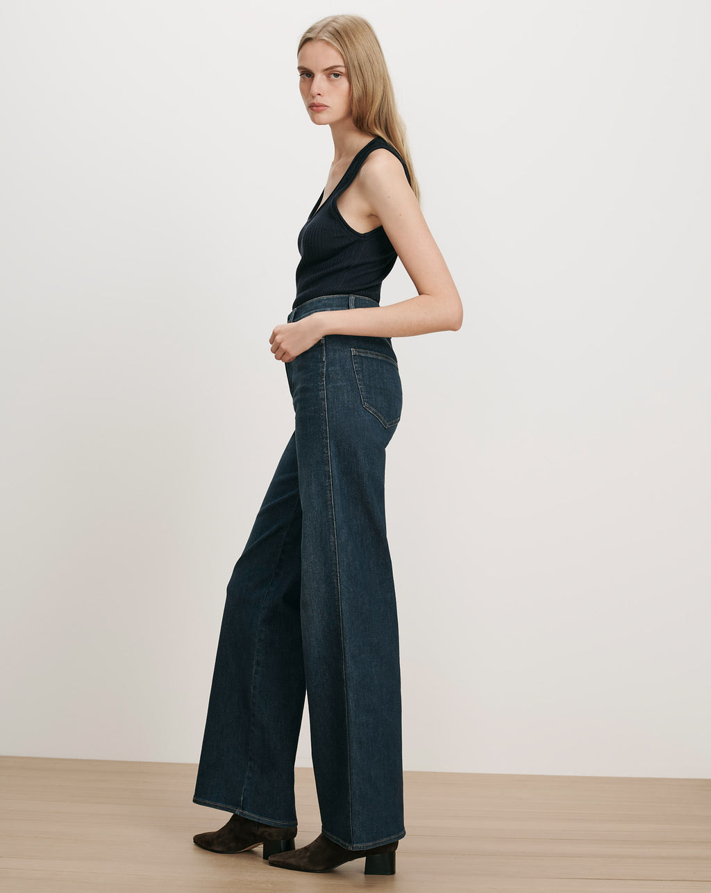 Veronica Beard Dark wash wide-leg jeans and black ribbed tank top.